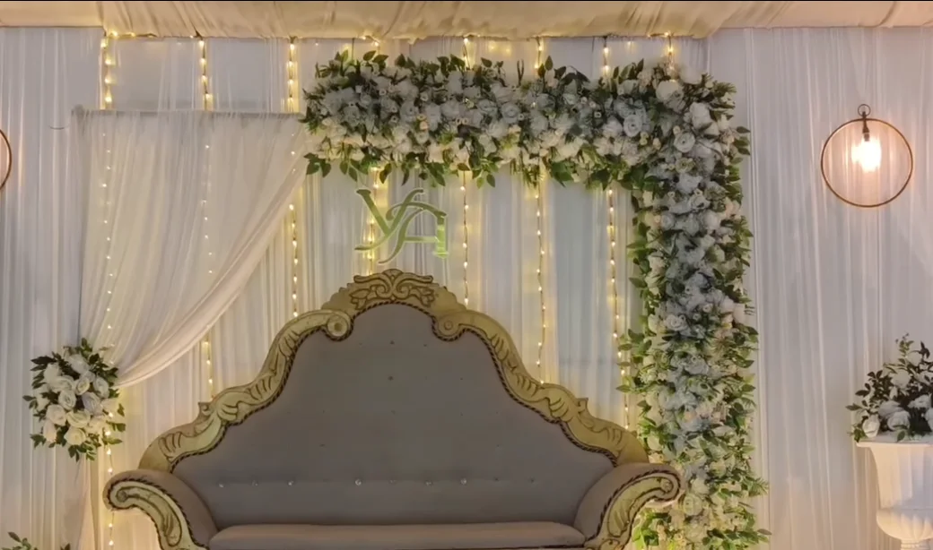 Golden Corner Wedding — Corner floral arch with fairy lights